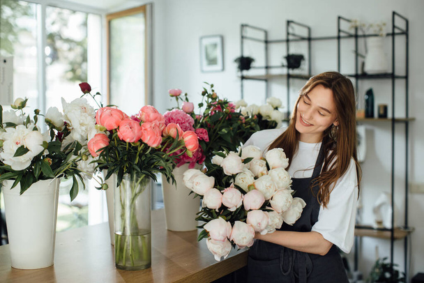 Florist woman in workspace of flower shop. - stock photo - Photo, Image