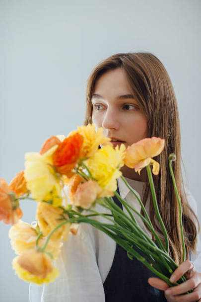 Portrait of a woman holding a bouquet of flowers - stock photo - 写真・画像