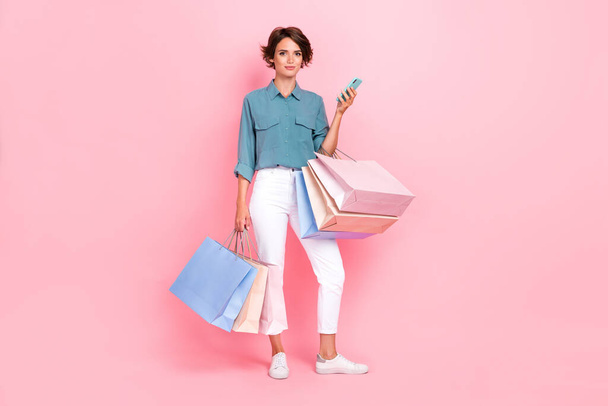 Full length photo of young adorable pretty positive woman hold package from delivery online shopping wireless payment black friday isolated on pink color background. - Fotografie, Obrázek