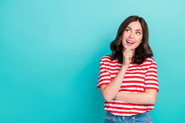 Photo of cheerful cute lady interested look empty space consider question decision striped trendy outfit isolated on cyan color background. - Φωτογραφία, εικόνα
