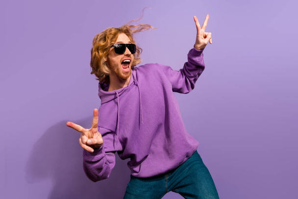 Photo of hooray beard millennial guy dance show v-sign wear sunglass sport clothes isolated on purple color background. - Foto, imagen