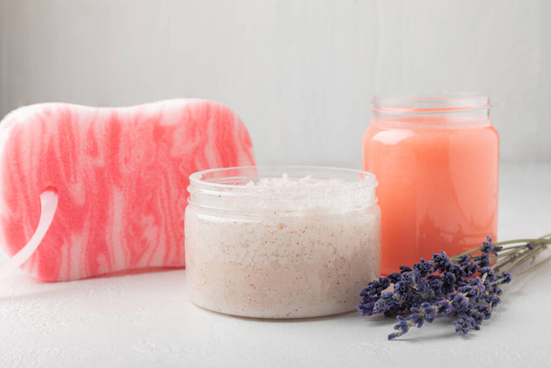 Natural lavender scrub on a white texture background.Body scrub. Body care. Sugar peeling scrub with argan oil and Himalayan salt. spa set - Zdjęcie, obraz
