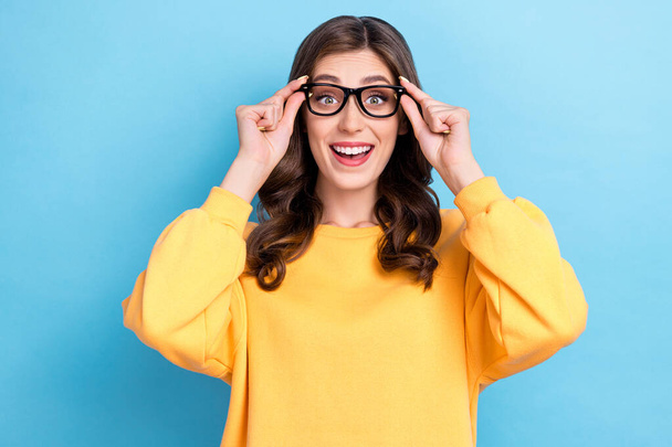 Closeup photo of young excited positive good mood woman wear yellow shirt hold try new eyeglasses cute businesswoman isolated on blue color background. - Photo, image