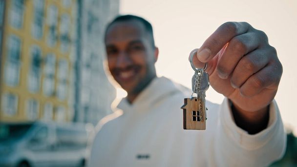 Happy homeowner buyer realtor estate agent latino man holding bunch keys selling flat of new apartment house advertising sold dwelling in modern district city renting accommodation housing improvement - Photo, Image