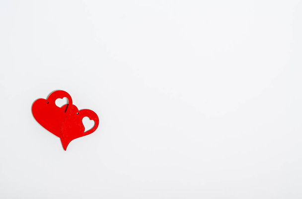 Two red wooden hearts on a white background with place for text. Love concept, congratulations, copy space, flat lay, banner, top view. - Fotoğraf, Görsel