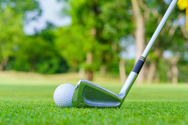 Golf ball on green grass ready to be struck on golf course. - Fotó, kép
