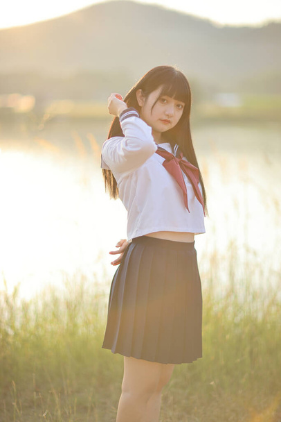 Asian High School Girls student looking at camera in countryside with sunrise - Fotografie, Obrázek