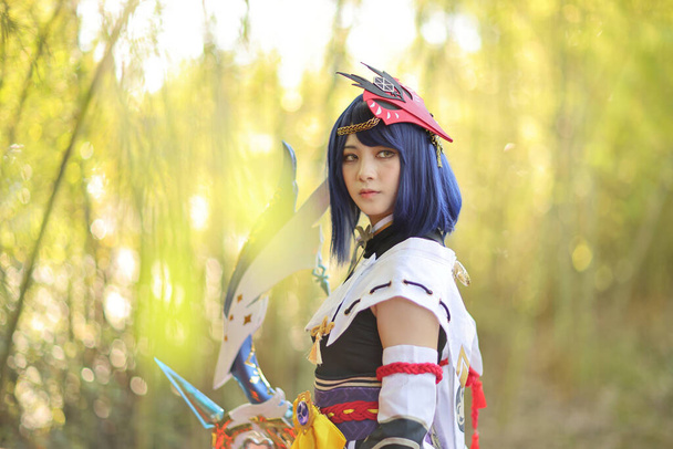Japanese young woman hunter cosplay with bow on Japanese garden - Photo, Image