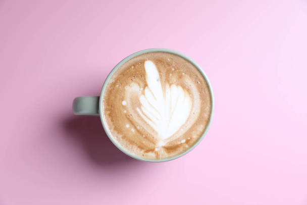 hot cappuccino with latte art isolated in pink background - 写真・画像