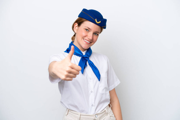 Repülőgép stewardess nő elszigetelt fehér háttérrel hüvelykujjal felfelé, mert valami jó történt - Fotó, kép