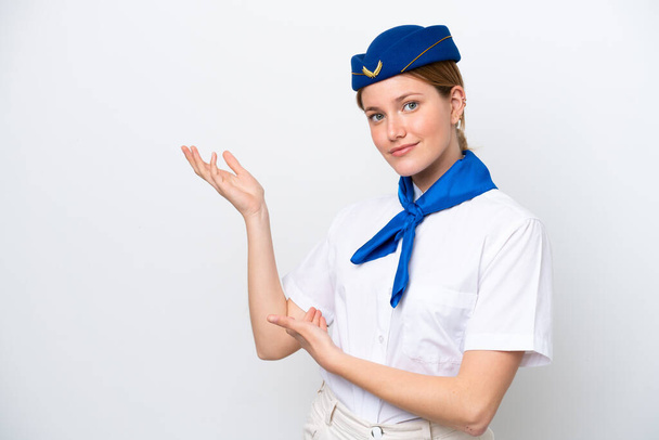 Airplane stewardess woman isolated on white background extending hands to the side for inviting to come - Photo, Image