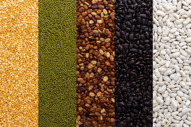 Different types of legumes, mung beans and yellow peas, brown, white and black beans, top view - Photo, Image