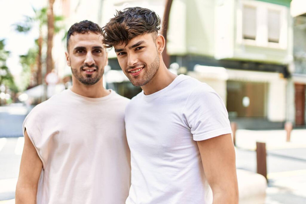 Two hispanic men couple smiling confident hugging each other standing at street - Photo, Image