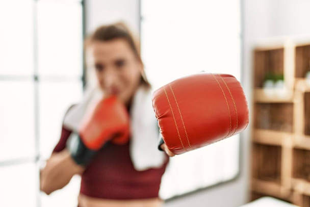 Middle age caucasian sporty woman boxing at home. - Fotó, kép
