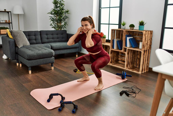 Middle age caucasian sporty woman training at home. - Valokuva, kuva