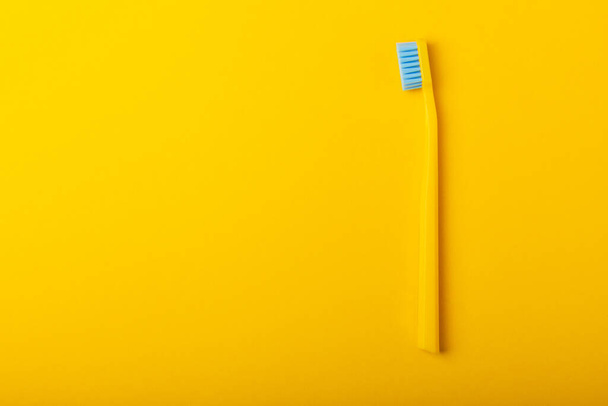 Toothbrushes. Oral care. Dental care. Composition with bright toothbrushes on a yellow background.Professional dental care. Copy space. Place for text.Fletley - Zdjęcie, obraz