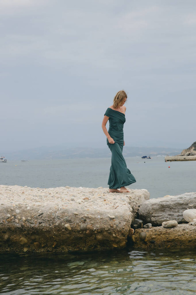 Divat szabadtéri portré női modell hosszú elegáns zöld ruha a strandon - Fotó, kép