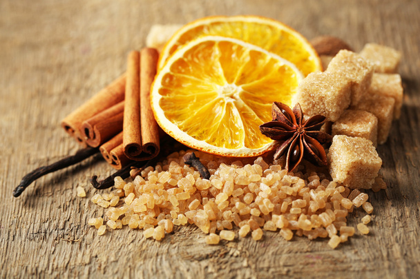Christmas spices, nuts and baking ingredients, close-up, on wooden background - Foto, afbeelding