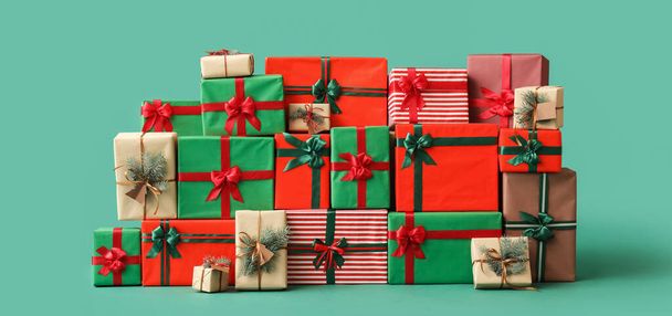 Different Christmas presents on green background - Photo, Image