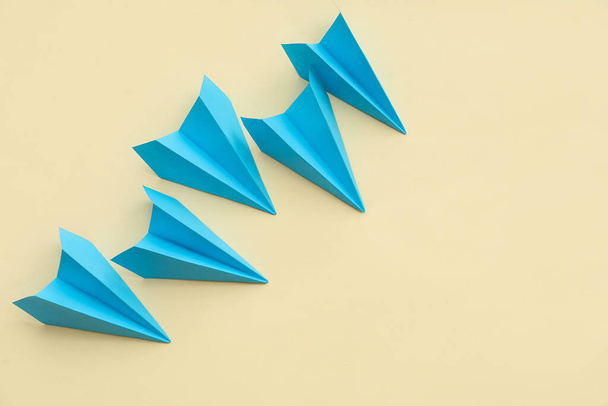 Blue paper planes on beige background - Photo, Image