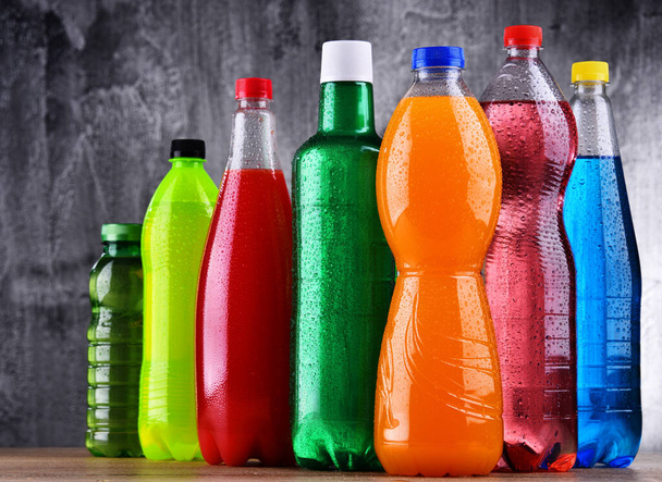 Plastic bottles of assorted carbonated soft drinks in variety of colors - Photo, Image