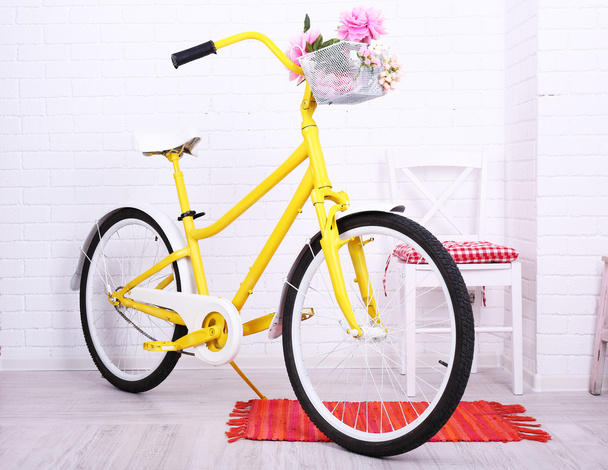 Yellow retro bicycle in spacious bright room - Photo, image