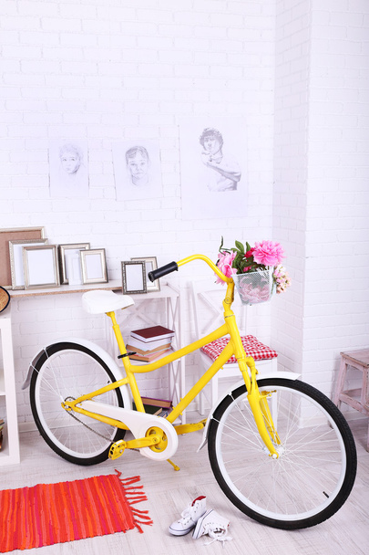 Yellow retro bicycle in spacious bright room - Photo, Image