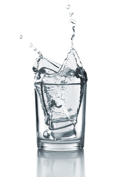 Water splash with ice in glass isolated on white - Valokuva, kuva
