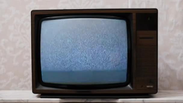 Nagranie 4K. Stary telewizor bez sygnału i efektu statycznego na ekranie. Koncepcja retro i telewizji. - Materiał filmowy, wideo