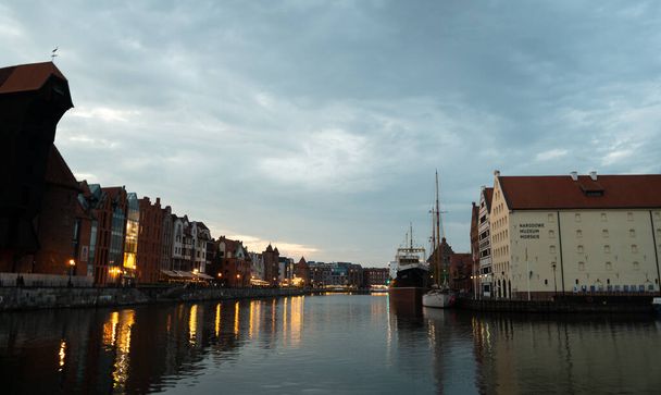 Scenic summer evening panorama of the architectural embankment of the Baltic port in the evening street of the Old Town GDANSK, POLAND - July 6, 2022 - Fotó, kép