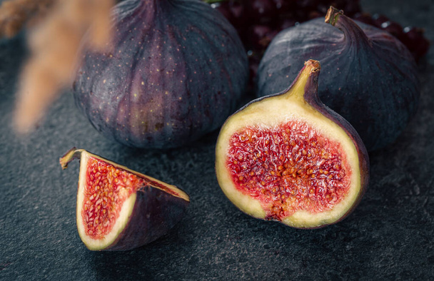 Juicy, ripe figs in a cut on a dark background, close-up. - Photo, Image