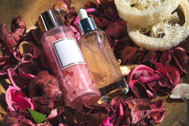 Spa composition with facial care products among rose petals, close up. - Photo, Image