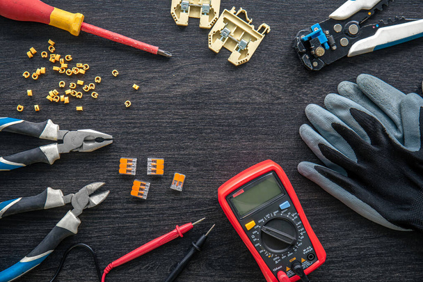 Flat lay composition with electrical tools on wooden background. - Foto, Bild