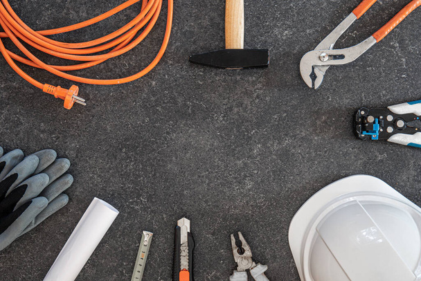 Flat lay composition with different construction tools on dark background. - 写真・画像