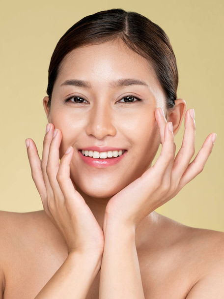 Closeup ardent young woman with healthy clear skin and soft makeup looking at camera and posing beauty gesture. Cosmetology skincare and beauty concept. - Foto, imagen