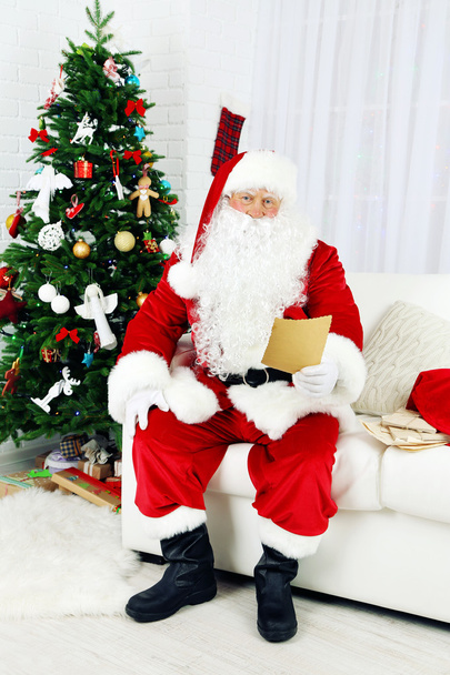 Santa Claus with list of presents - Foto, afbeelding