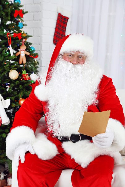 Santa Claus with list of presents - Фото, зображення