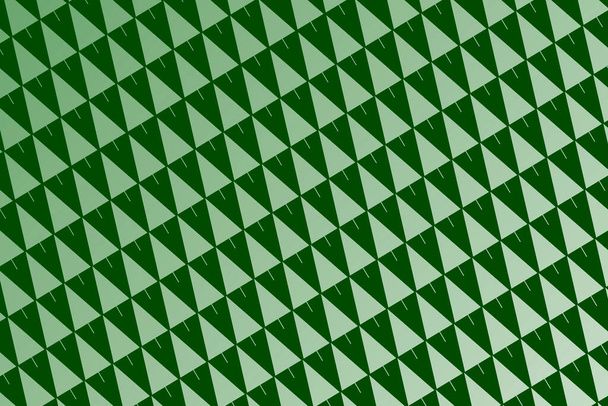 un gráfico de fondo verde brillante con el patrón del árbol de Navidad en una diagonal - Foto, Imagen