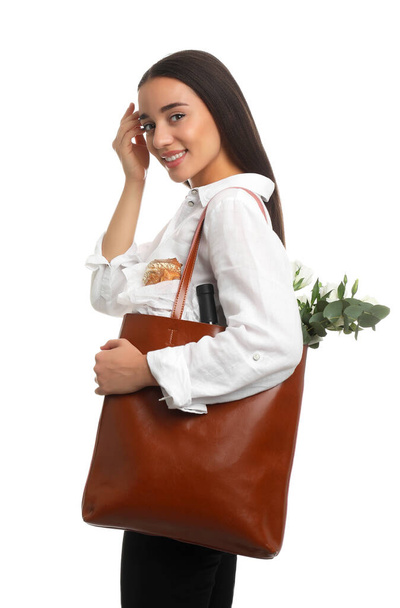 Young woman with leather shopper bag on white background - Foto, imagen