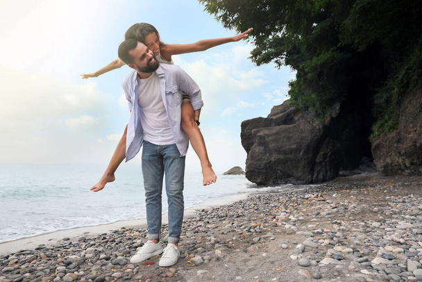 Happy young couple having fun on beach sea. Space for text - Photo, image