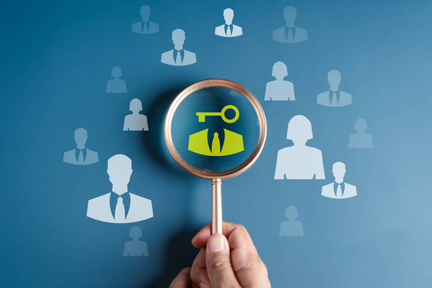 HRM or Human Resource Management, Magnifier glass focus to manager unlock business key icon which is among staff icons for human development recruitment leadership and customer target group concept. - Foto, Imagem