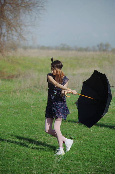 Hippie woman with umbrella dancing outdoors - Φωτογραφία, εικόνα