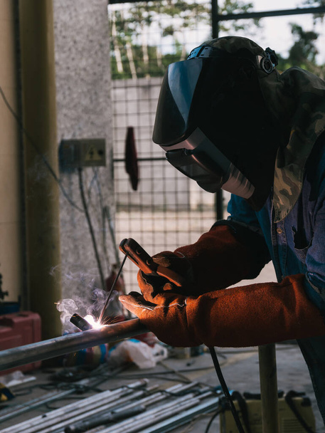 Iron soldering, Man working on iron soldering, welding sparks, men - Foto, Imagem