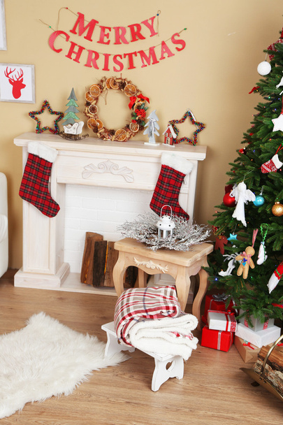 Decorated fireplace near Christmas tree. Christmas decoration concept - Zdjęcie, obraz