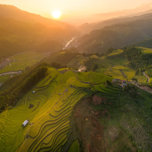 Aerial view of golden rice terraces at Mu cang chai town near Sapa city, north of Vietnam. Beautiful terraced rice field in harvest season in Yen Bai, Vietnam. Travel and landscape concept. Selective focus - Fotografie, Obrázek