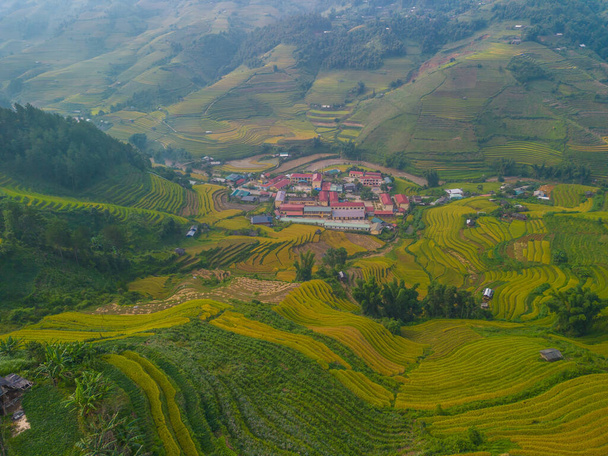 Aerial view of golden rice terraces at Mu cang chai town near Sapa city, north of Vietnam. Beautiful terraced rice field in harvest season in Yen Bai, Vietnam. Travel and landscape concept. Selective focus - Fotó, kép