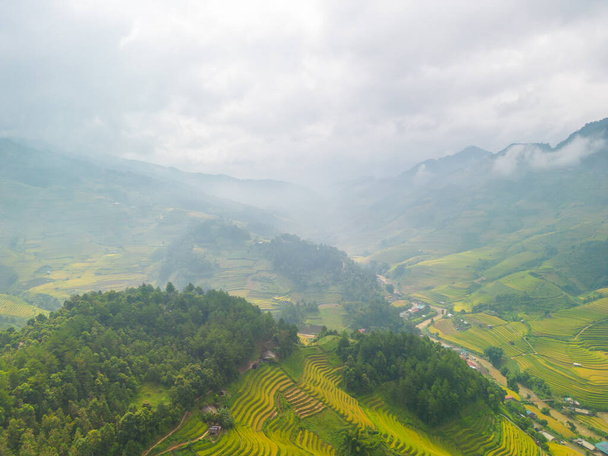 Aerial view of golden rice terraces at Mu cang chai town near Sapa city, north of Vietnam. Beautiful terraced rice field in harvest season in Yen Bai, Vietnam. Travel and landscape concept. Selective focus - Foto, Imagem