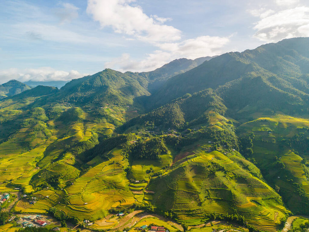 Aerial view of golden rice terraces at Mu cang chai town near Sapa city, north of Vietnam. Beautiful terraced rice field in harvest season in Yen Bai, Vietnam. Travel and landscape concept. Selective focus - Foto, Imagem