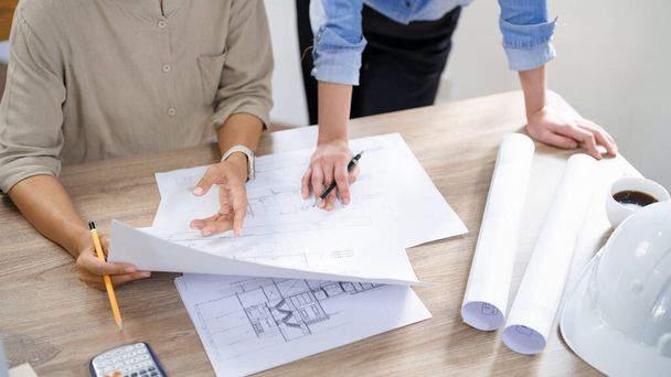 Concept of engineering consulting, Two female engineers is checking blueprint of building together. - Foto, imagen