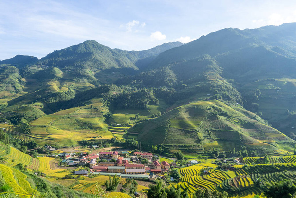 Aerial view of golden rice terraces at Mu cang chai town near Sapa city, north of Vietnam. Beautiful terraced rice field in harvest season in Yen Bai, Vietnam. Travel and landscape concept. Selective focus - Photo, image
